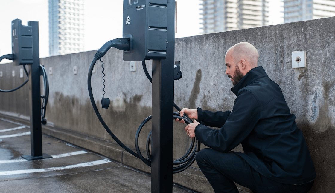 An image of an installer or maintenance person working on an EV charger