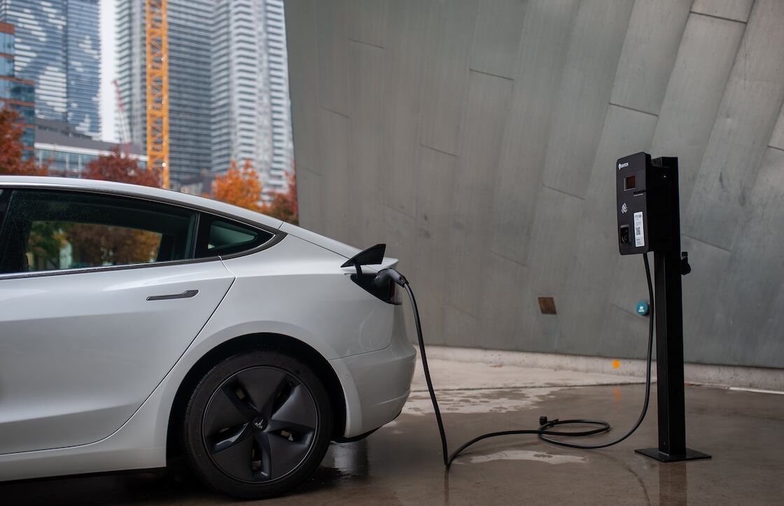 An image of an EV plugged into an EV charger.